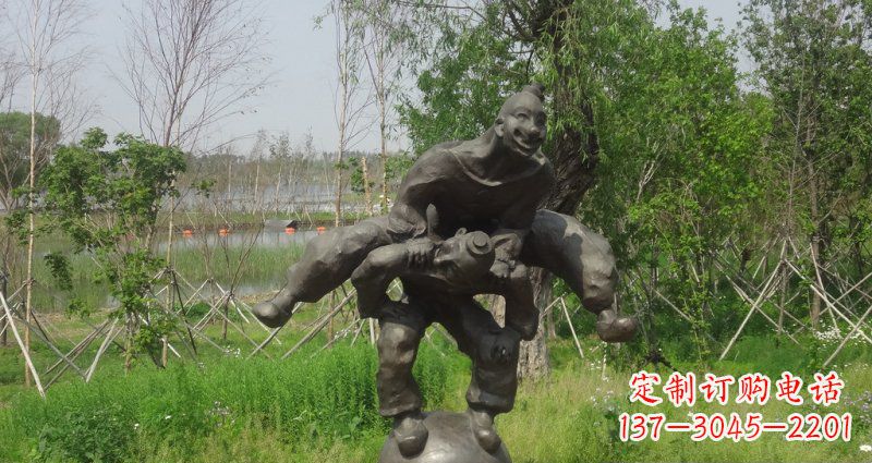 河源园林站在球上面跳山羊的人物景观铜雕